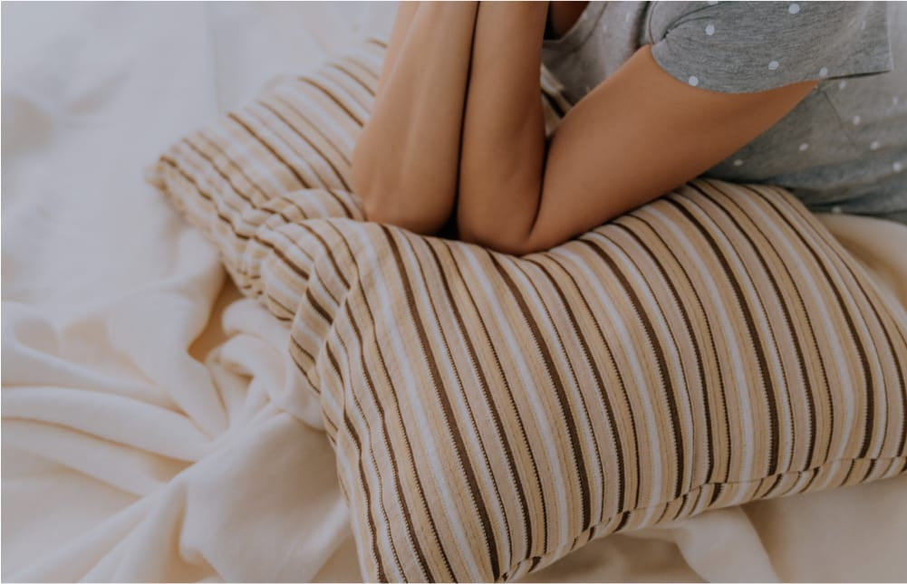 Womans elbows resting on Essentia pillows